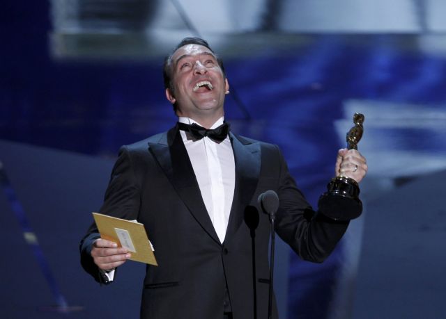 French actor Jean Dujardin accepts the Oscar for Best Actor for his role in the film "The Artist" at the 84th Academy Awards in Hollywood